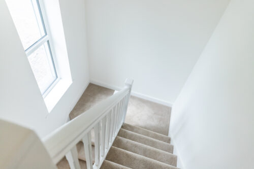 The Aspley staircase with feature window - new build home, Russell Armer by Genesis Homes
