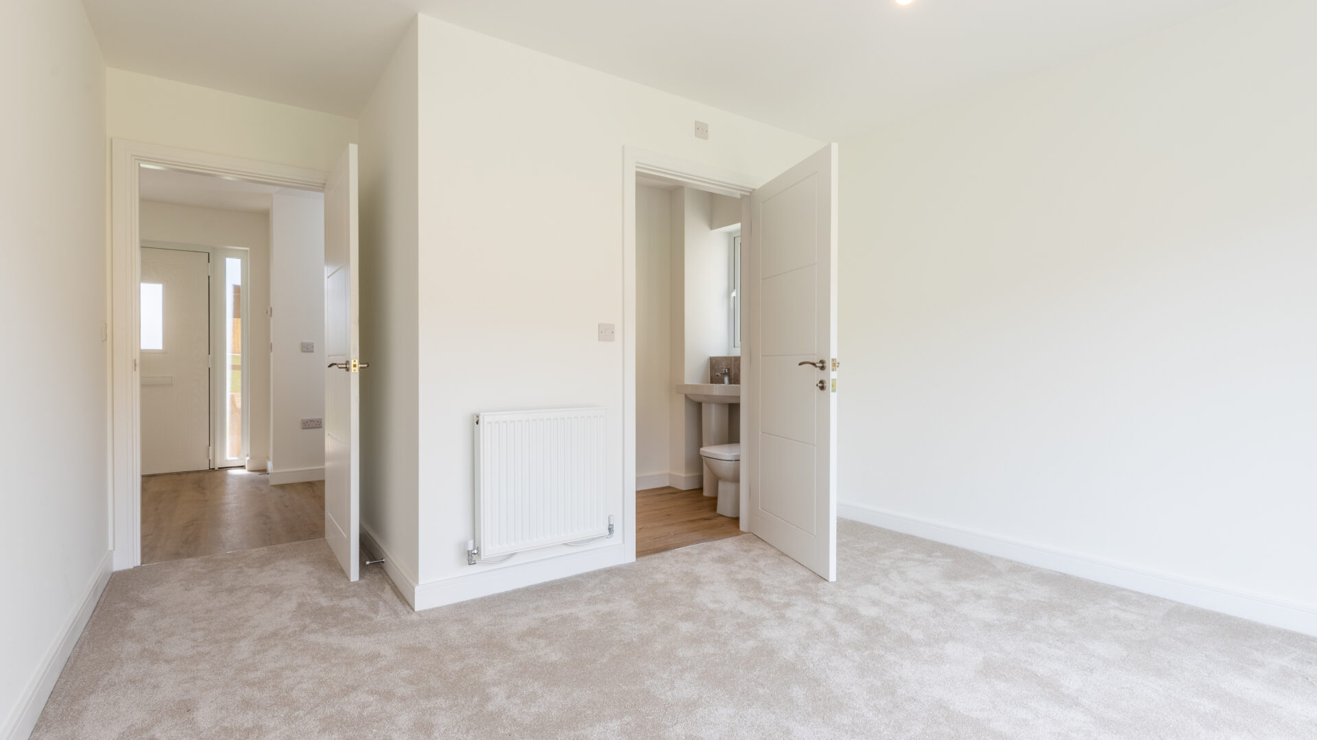 The Aspley master bedroom with en-suite bathroom - new build home, Russell Armer by Genesis Homes