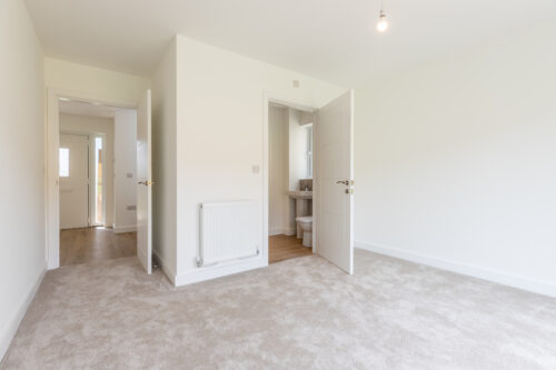 The Aspley master bedroom with en-suite bathroom - new build home, Russell Armer by Genesis Homes