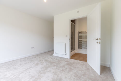 The Aspley master bedroom with en-suite bathroom - new build home, Russell Armer by Genesis Homes