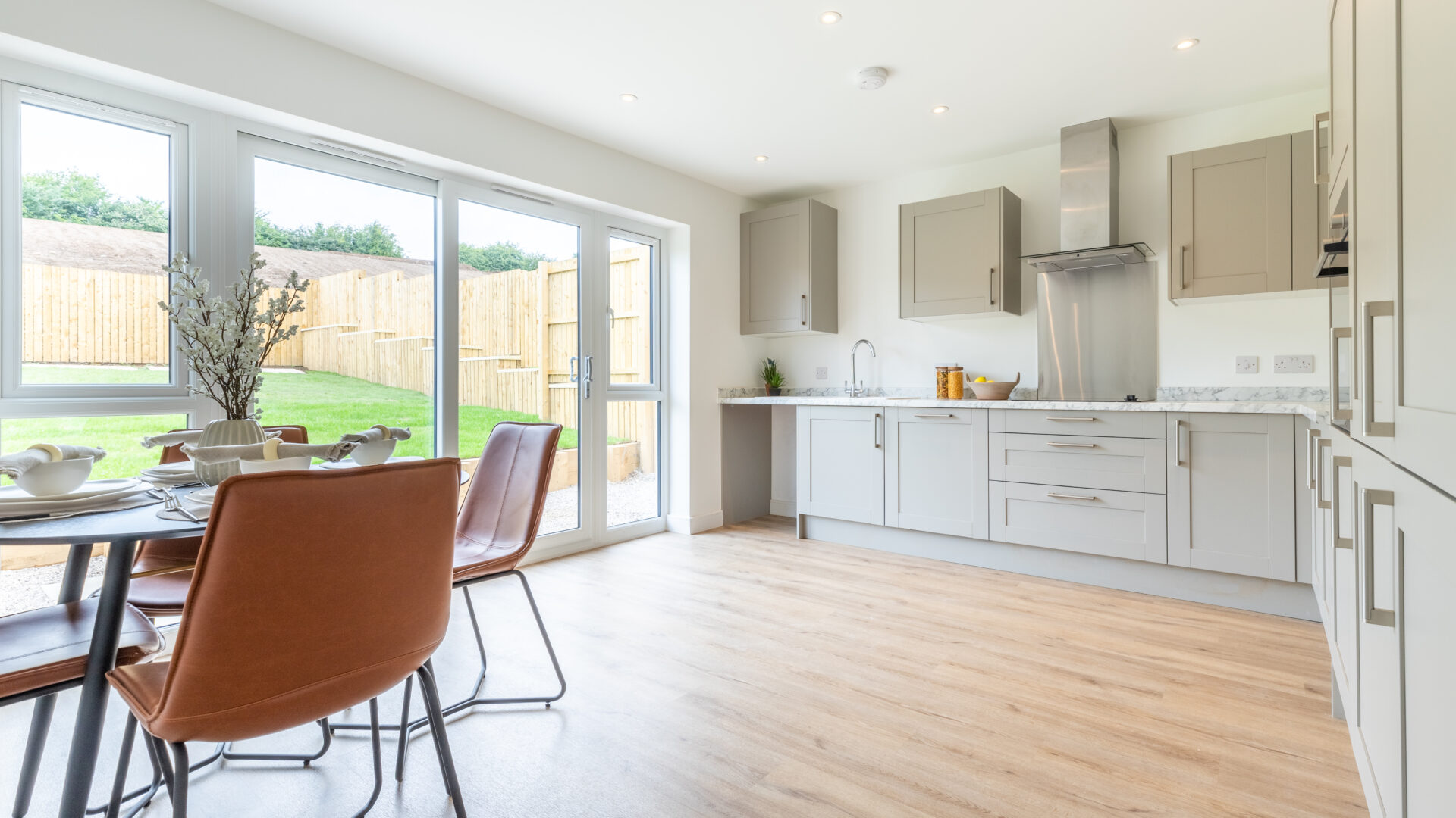 The Aspley kitchen/dining area with sliding doors - new build home, Russell Armer by Genesis Homes
