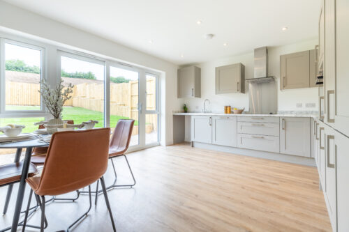 The Aspley kitchen/dining area with sliding doors - new build home, Russell Armer by Genesis Homes