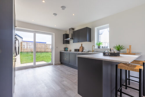The open plan kitchen/dining area in the 3-bedroom Sedgwick at Meadow Rigg in Kendal - Genesis Homes