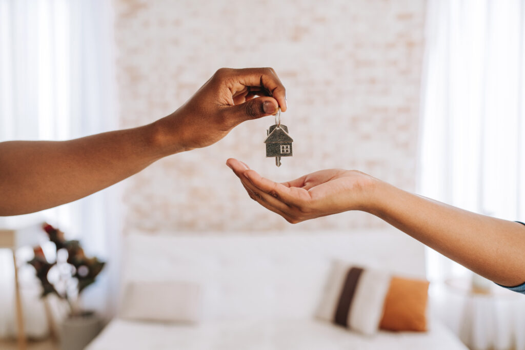 Estate agent giving a man the keys to his new home