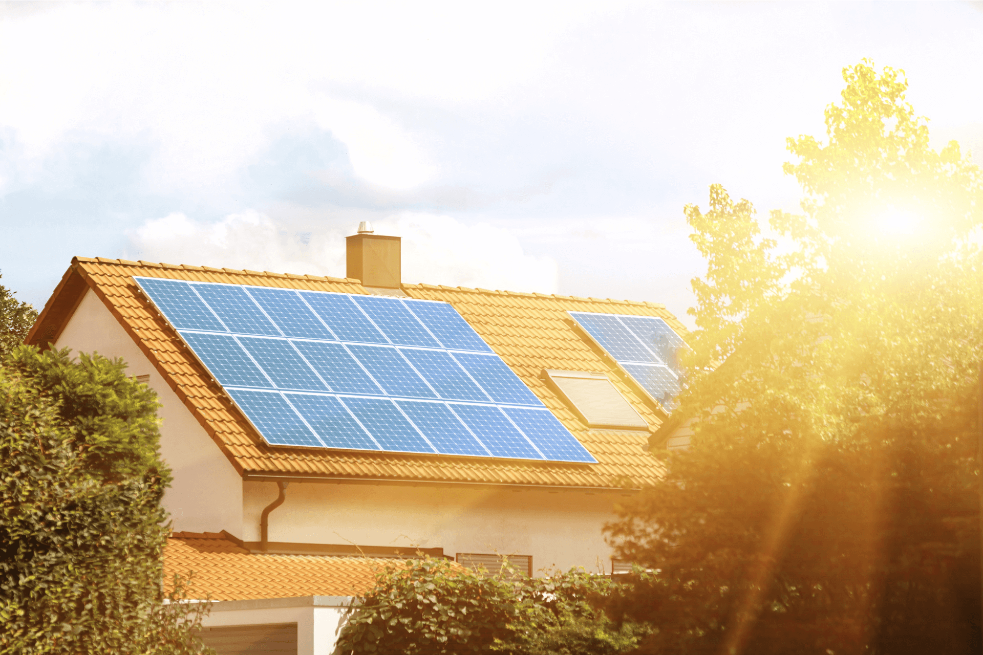 Roof with solar panels and sunlight shining on them through the trees