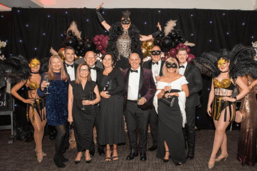 Group of people in black tie and masquerade masks