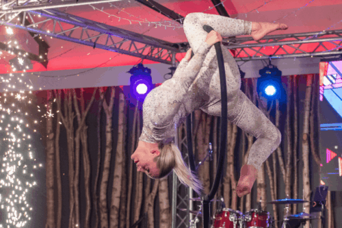 Female acrobat bent around a hoop