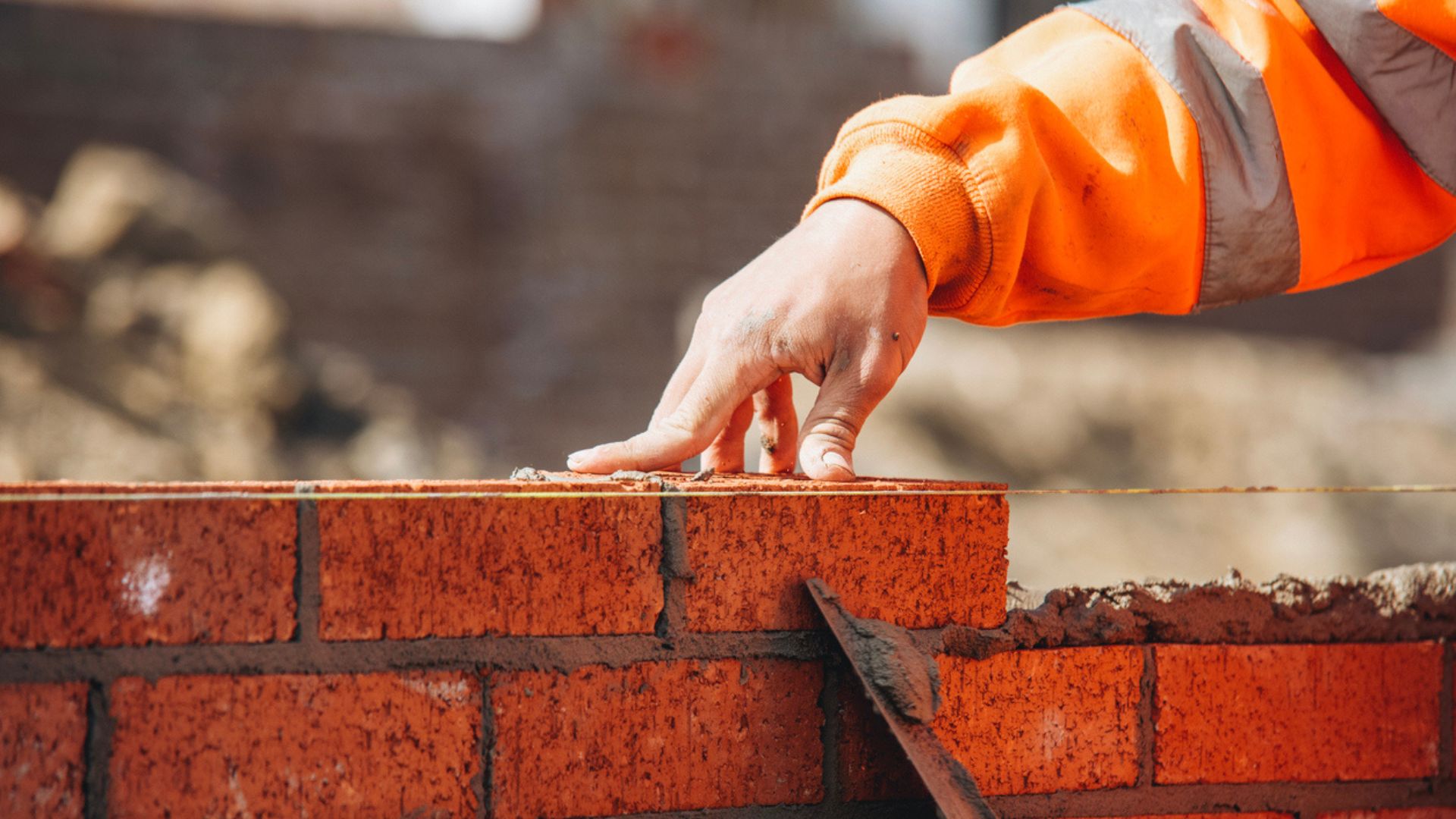 Builder laying bricks for a traditional build house