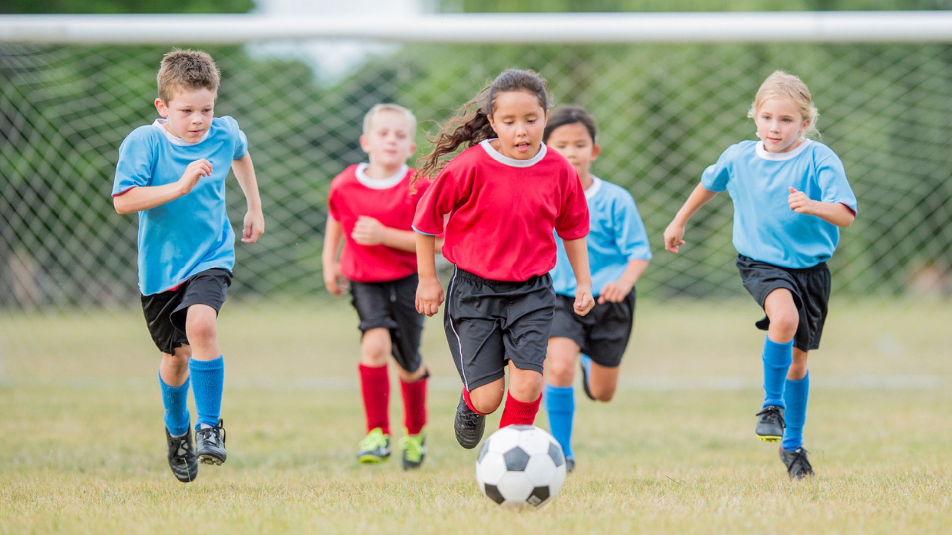 Group of children playing football together
