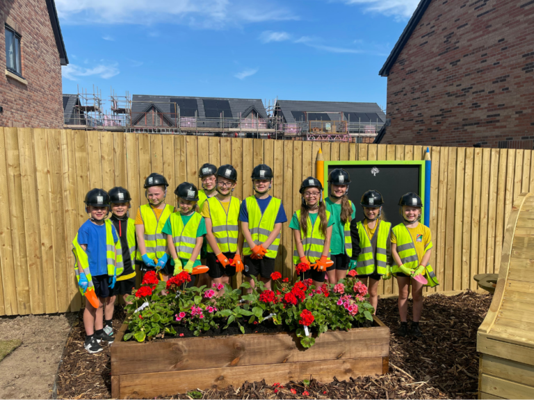 Yewdale Primary School planting in the show home garden at Sandsfield Way in Carlisle - Genesis Homes