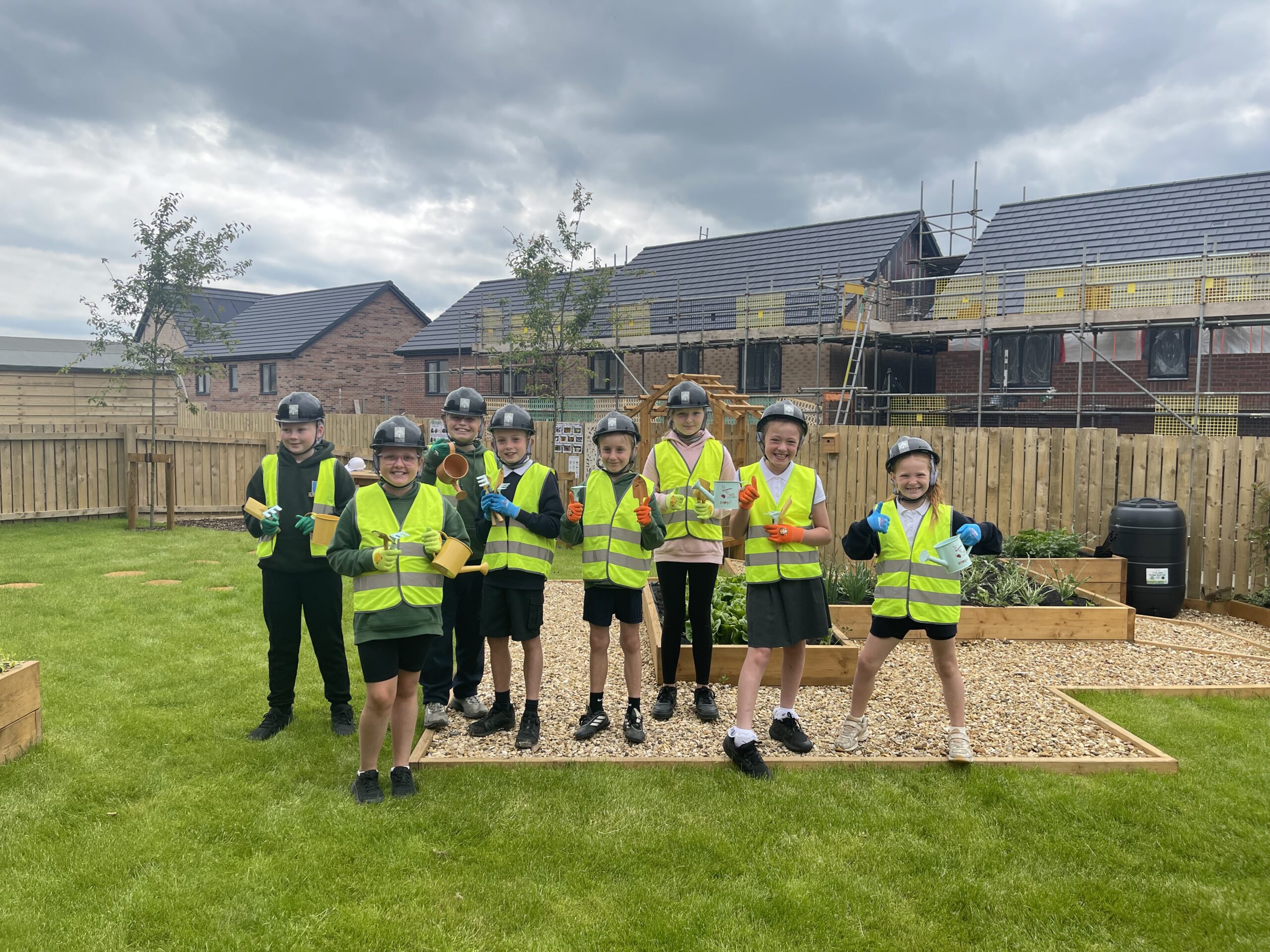 St Paul's School pupils planting in show home garden at Genesis Homes development in Seaton