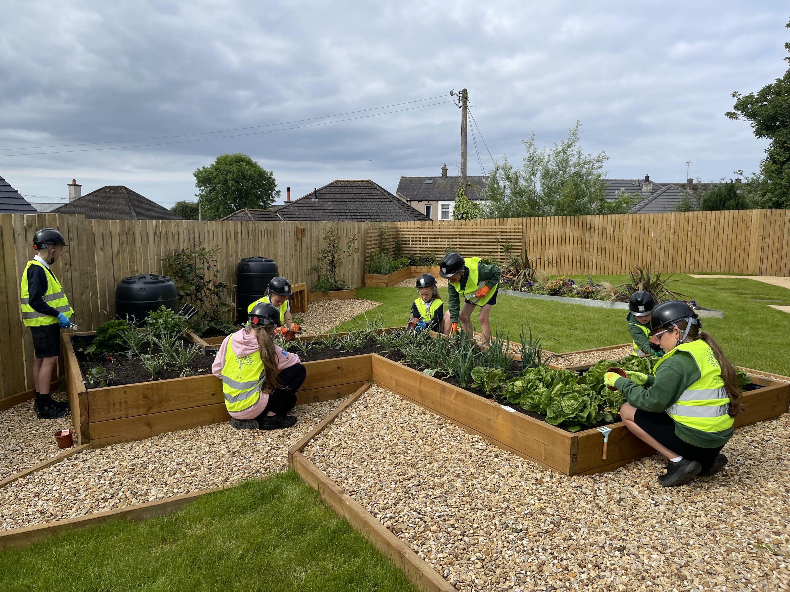 St Paul's School pupils planting in show home garden at Genesis Homes development in Seaton